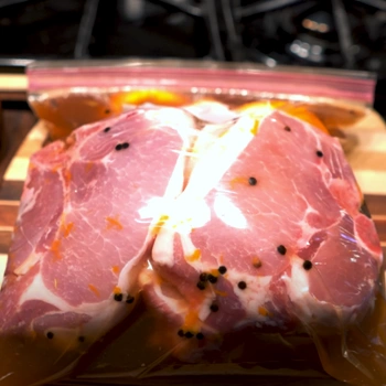 Brined pork inside a zip tied plastic