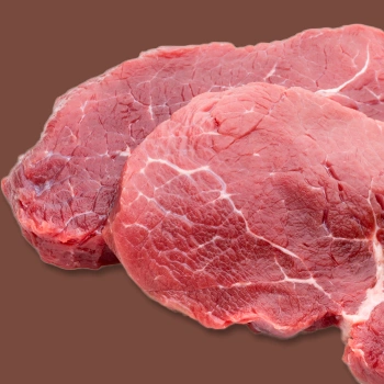 Raw beef on brown background