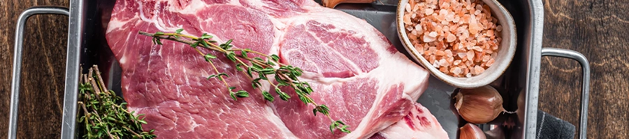 Raw steak on meal tray with different spices