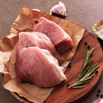 Raw meat on circular wooden platform