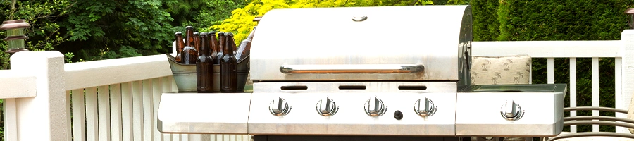 A closed lid gas grill outdoors