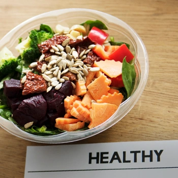 A healthy meal bowl with a note under