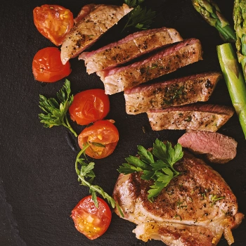 A top view of steak with vegetables