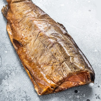 Hot smoked trout on marble platform table