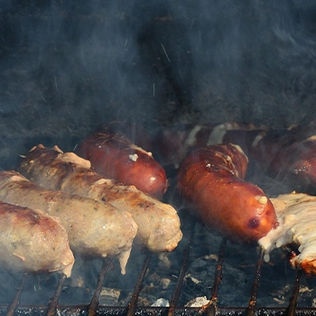 Close up image of meats inside smoker