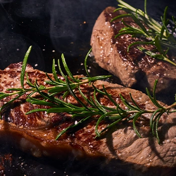 A seared meat with rosemary