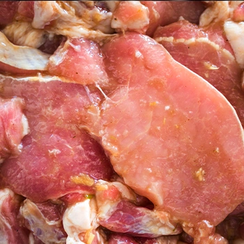 Marinated raw pork close up image