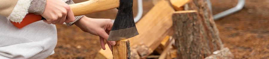 Chopping off a piece of wood logs