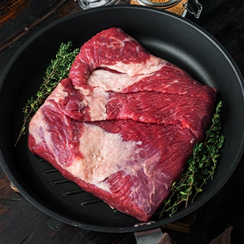 Raw beef brisket on pan