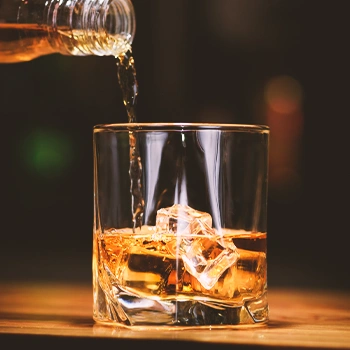 Whiskey being poured on a glass