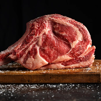 Tomahawk steak on cutting board black background