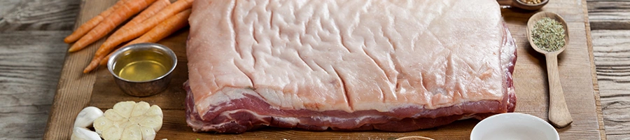 Raw pork brisket on cutting board