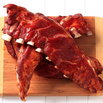 A freshly smoked ribs on a cutting board