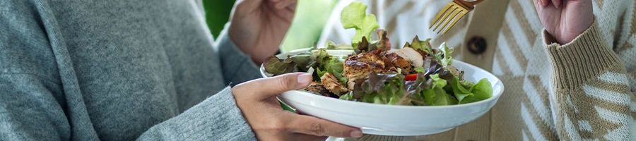 bowl of salad being shared