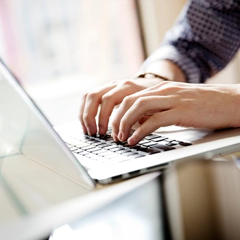 hand view of a person using laptop