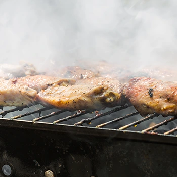 grilling meat with white smoke