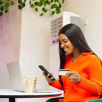 woman using phone and credit card