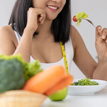 woman smiling while eating