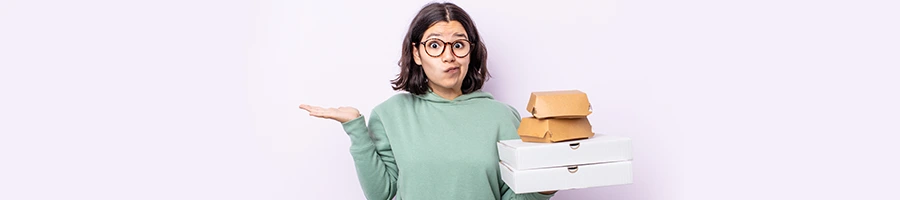 woman shrugging while holding packages