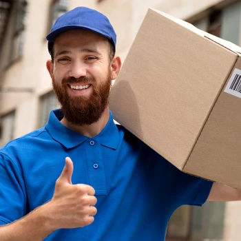 A delivery guy giving a thumbs up while holding box