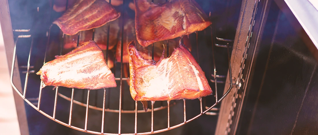 Meat being smoked inside a smoker