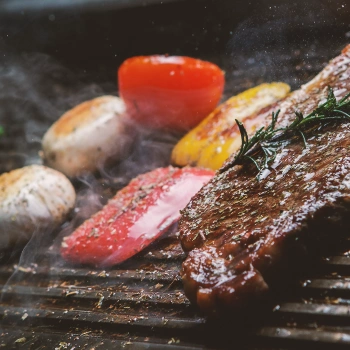 A variety of food being grilled