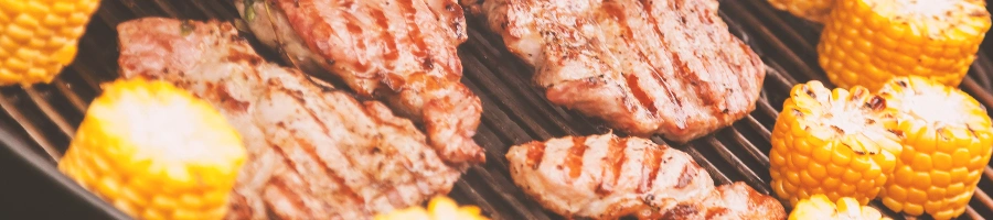 Steak and corn being grilled