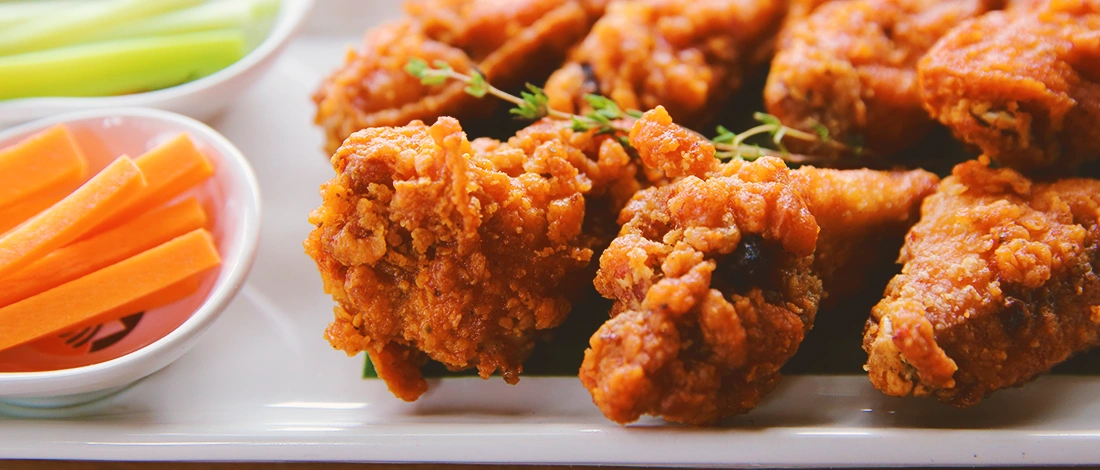 Fried chicken on a plate with vegetables