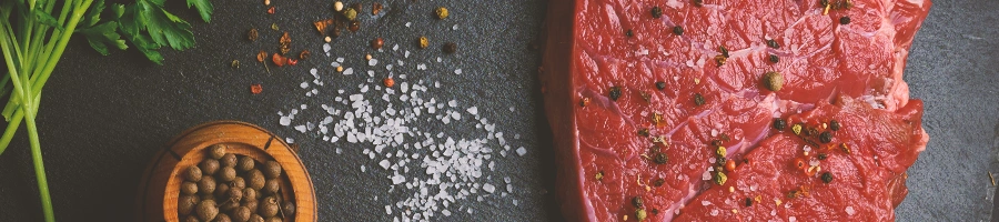 Raw steak with ingredients on the side