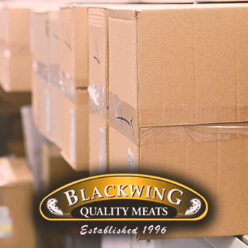 Close up shot of boxes with the blackwing meats logo in front