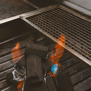 Close up shot of a grill with charcoal