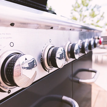 A row of igniter switches on a gas grill