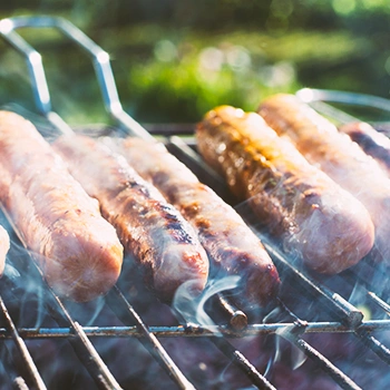 Sausages being grilled outside