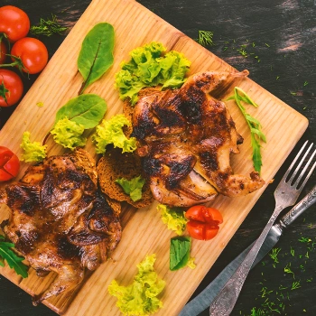 Cooked chicken on a wooden board