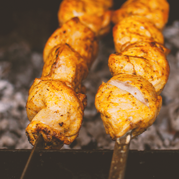 Potatoes being cooked on a charcoal grill