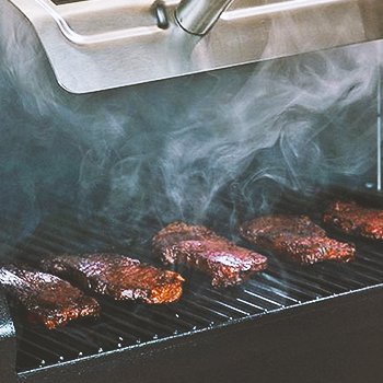 Meat inside a grill smoker