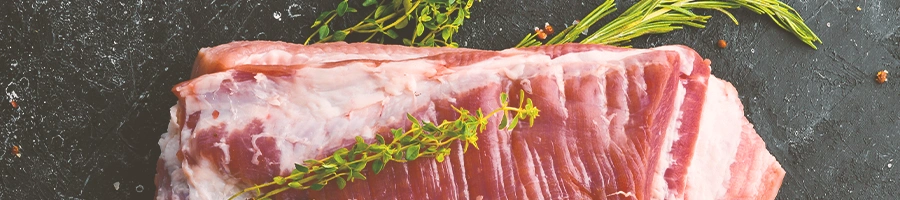 Top view of raw brisket with herbs