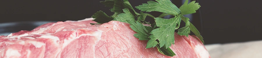 Raw steak with herbs on top