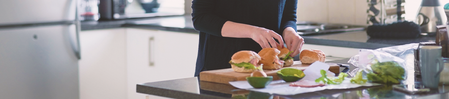 A person making making burgers in a kitchen