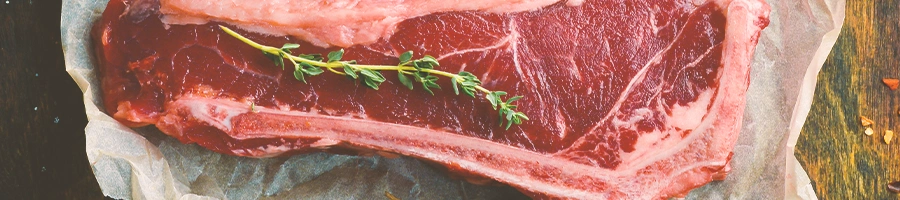 Top view of new york strip steak with herbs