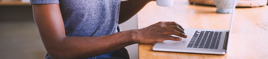 A person using a laptop in a kitchen