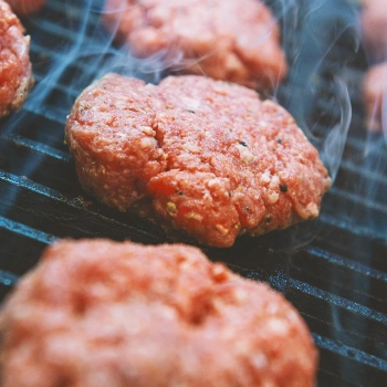 Hamburger patties being grilled