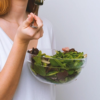 A person eating salad