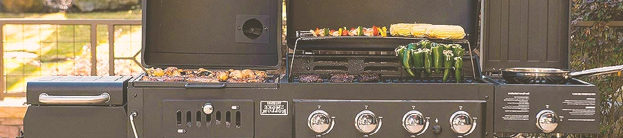 A gas and grill smoker outside with meat on