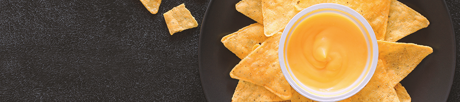 Top view of nachos with a cheese dip