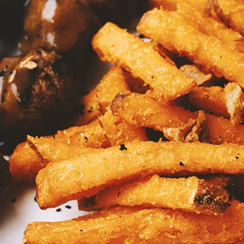 Close up shot of fries and meatballs