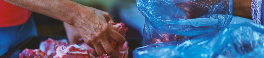 A person buying meat in a market