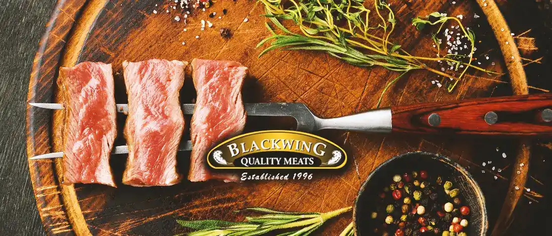 Meat on a fork with the blackwing meats logo