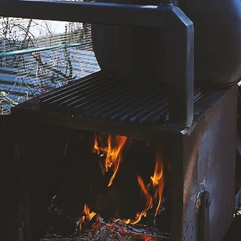 Close up shot of a food smoker's fuel embers