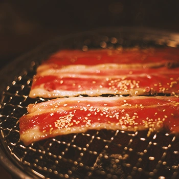 Meat being cooked on a korean bbq grill
